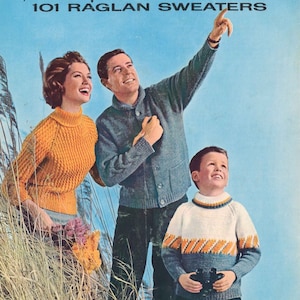 May include: A family of three wearing sweaters, standing in a field of tall grass. The man is pointing upwards, the woman is holding a bouquet of flowers, and the child is holding binoculars. The image is from a knitting pattern book titled "Spinnerin 101 Raglan Sweaters, Volume 309, Lesson 2".