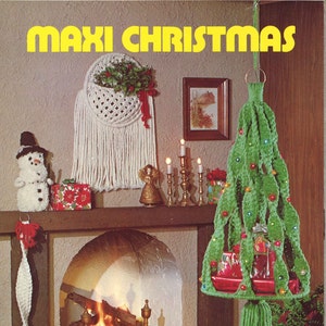 May include: A vintage image with a Christmas theme, showcasing a crocheted Christmas tree, snowman, and macrame wall hanging. The text "MAXI CHRISTMAS" is in yellow. The scene includes a fireplace and candles, creating a warm, festive atmosphere.