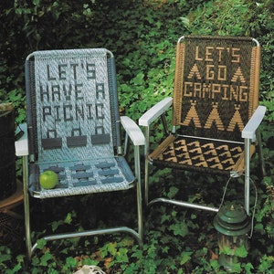 May include: Two folding chairs with woven seats and backs. The chair on the left has the text "LET'S HAVE A PICNIC" on the back. The chair on the right has the text "LET'S GO CAMPING" and a pattern of triangles on the back.