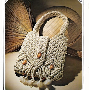 May include: A beige macrame bag with wooden beads and fringe. The bag is made with a knotting technique and has a natural straw color.