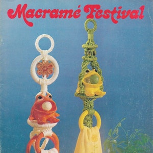 May include: A macrame towel rack with two hanging frogs. One frog is orange and the other is yellow. The towel rack is made with green and white yarn. The image includes the text "Macrame Festival" and "MM 341".