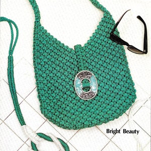 May include: A green crocheted bag with a white and green strap. The bag has a silver and turquoise oval-shaped embellishment. The text "Bright Beauty" is visible below the bag.