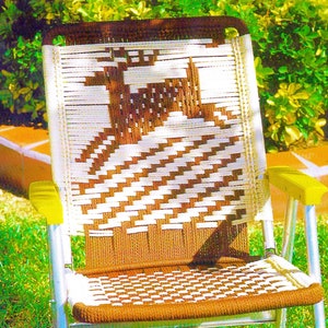May include: A brown and white woven chair with a yellow metal frame. The chair is made of a woven material that creates a checkered pattern. The chair is sitting on a green lawn.
