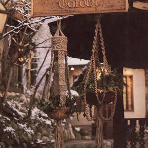 May include: A wooden sign with the text "The Four Seasons Garden" hanging above a doorway. Two macrame plant hangers with potted plants hang from the ceiling. The scene is set in a snowy, wintery environment.