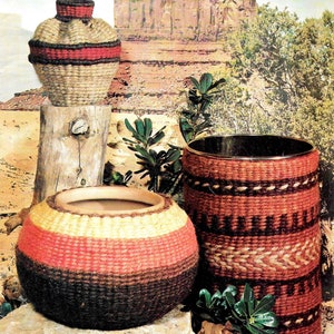 May include: Three woven baskets in a Southwestern style. A tall, cylindrical wastebasket, a round flower pot, and a smaller urn. The baskets are made with natural fibers and feature brown, red, and beige stripes.