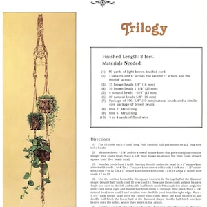 May include: A macrame plant hanger with three woven baskets, each holding greenery. The design includes intricate knotwork and decorative elements. The text "Trilogy" is visible. Finished length is 8 feet.