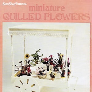 May include: A vintage book cover for a craft project titled "miniature QUILLED FLOWERS" by Betty Christy and Doris Tracy. The cover features a white miniature flower cart with a variety of colorful flowers and greenery.