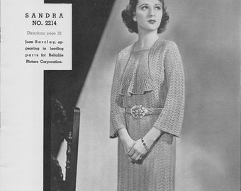 May include: A vintage black and white photograph of a woman wearing a knitted dress and bolero jacket. The dress has a decorative belt. The text "SANDRA NO. 2214" is visible in the upper left corner.