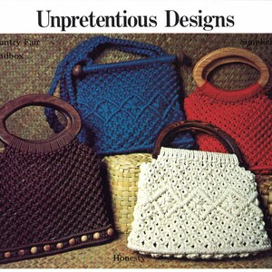 May include: Four macrame bags with wooden handles. The bags are in different colours: brown, blue, red, and white. The bags are labelled with the names "Country Fair Bandbox", "Simplicity", "Honesty", and "Country Fair Bandbox".