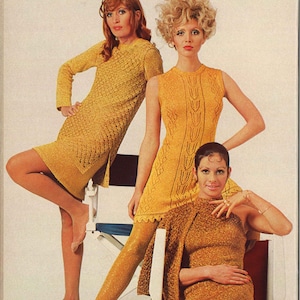 May include: Three women wearing yellow knit dresses. The woman on the left is wearing a short-sleeved dress with a geometric pattern. The woman in the middle is wearing a sleeveless dress with a cable knit pattern. The woman on the right is wearing a long-sleeved dress with a sparkly texture.