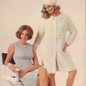 May include: Two women wearing crocheted dresses. The woman on the left is wearing a light blue dress and sitting on a white director's chair. The woman on the right is wearing a white dress and a white beret.