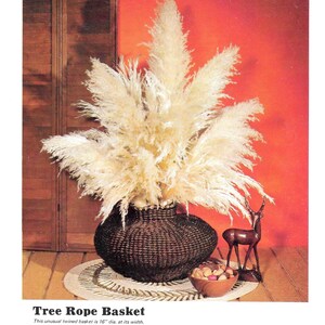 May include: A large, brown, woven basket with a 16-inch diameter, filled with dried pampas grass. The basket is sitting on a wooden floor with a woven rug underneath.