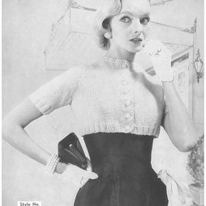 May include: A vintage black and white image of a woman wearing a knitted bolero sweater with a button-up front and a high-waisted skirt. She is also wearing white gloves and holding a small purse. The image includes the text "Style No. 484".