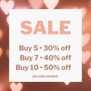 May include: A white square with pink text that reads "SALE" and a list of discounts: "Buy 5. 30% off", "Buy 7. 40% off", "Buy 10. 50% off". The text below the discounts reads "(no code needed)". The background is a blurry image of pink hearts.