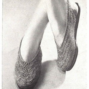 May include: A pair of crocheted slippers with a pointed toe and a v-shaped opening at the top.