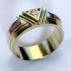 May include: A gold band ring with a triangular diamond and red gemstones. The ring has a geometric design.