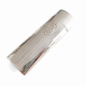 May include: A rectangular silver-toned metal case with a hinged lid, featuring a fine vertical pinstripe texture across the entire surface. A circular emblem containing the stylized letters GH is centered on the front of the case body.