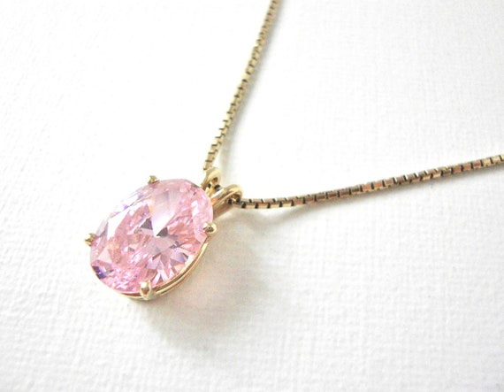 Gold necklace with pink on sale stone