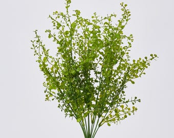 May include: A bundle of artificial greenery with small, round, light green leaves. The stems are a darker green, and the overall arrangement is dense and full, perfect for floral arrangements or home decor.