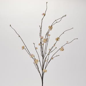 May include: A single stem of artificial flowers with delicate pink and cream blossoms. The branches are brown and spread out in a natural, graceful way.