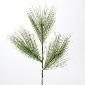 May include: A green artificial pine sprig with three branches. The sprig is perfect for adding a touch of greenery to your home decor.