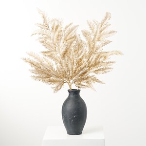 May include: A black ceramic vase with a textured surface holds a bouquet of dried golden fern branches.