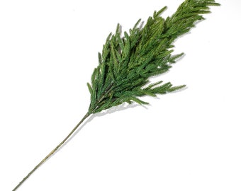 May include: A long, green artificial pine branch with a brown stem. The branch is ideal for adding a touch of greenery to your home decor.