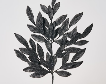 May include: Black glitter artificial leaf spray with a stem. The leaves are arranged in a cascading pattern.