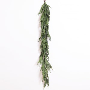 May include: A long, green garland of artificial pine branches, perfect for adding a touch of greenery to your home decor.