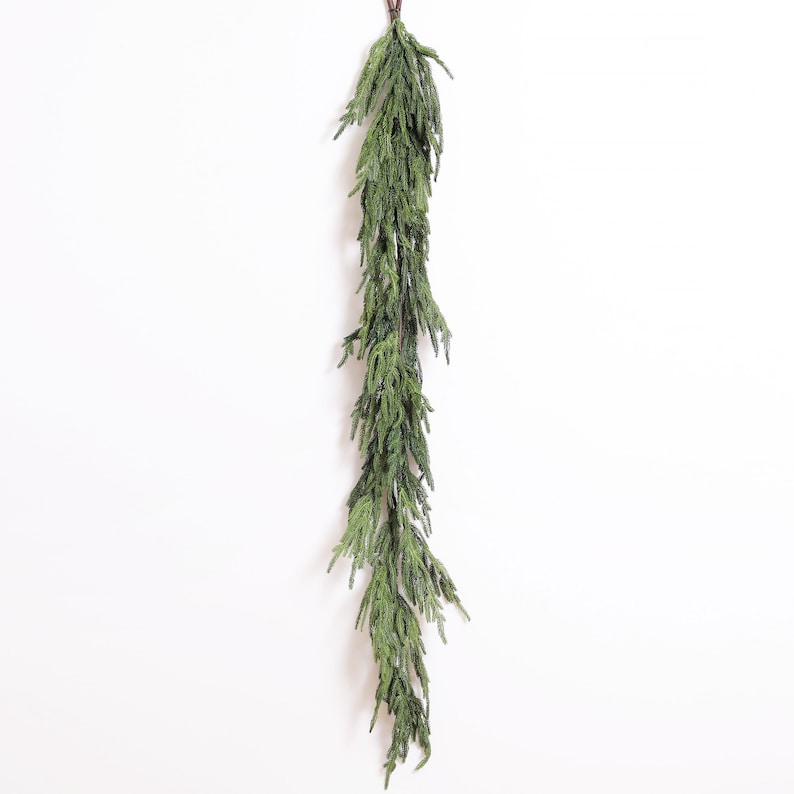 May include: A long, green garland of artificial pine branches, perfect for adding a touch of greenery to your home decor.