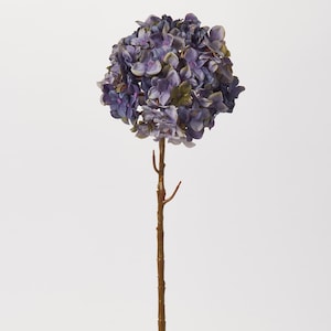 May include: A single stem artificial hydrangea flower with a purple and blue bloom. The stem is brown and has a few branches.