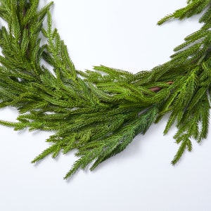 May include: A green artificial pine garland with long, thin needles. The garland is perfect for adding a touch of greenery to your home decor.