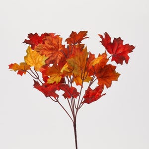May include: A bouquet of artificial fall leaves in shades of red, orange, and yellow. The leaves are arranged in a cluster and have a realistic appearance.
