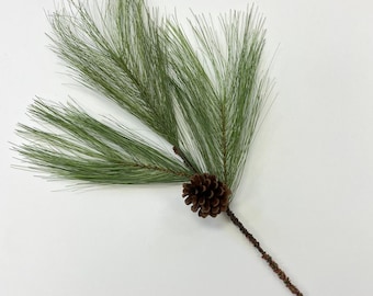 May include: A single artificial pine sprig with a brown pine cone. The sprig is green and has a long, brown stem.
