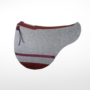 May include: A gray felt saddle pad with a burgundy trim and a black strap. The pad has a burgundy felt underside.