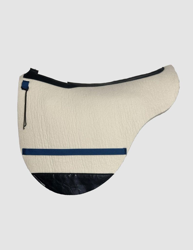 May include: A white sheepskin saddle pad with a black leather trim and a blue strap.