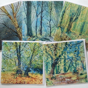 May include: Set of five watercolor paintings depicting various scenes of a forest with trees and foliage in shades of green, blue, and yellow.