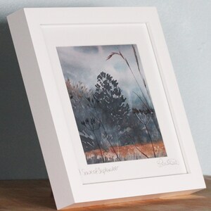 May include: A framed watercolor painting of a landscape with tall grasses and trees in shades of blue and brown. The painting is titled "First of September" and signed by the artist.