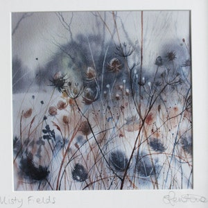 May include: A watercolor painting of a misty field with tall, dried grasses and wildflowers. The painting is done in shades of gray, brown, and blue, with a soft, ethereal feel.