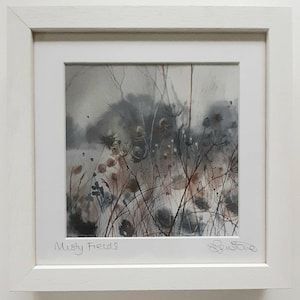 May include: A watercolor painting of a misty field with tall grasses and wildflowers. The painting is framed in a white frame and signed "Misty Fields" in the bottom left corner and "Ben Stowe" in the bottom right corner.