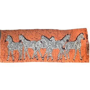 May include: A rectangular orange fabric with a brown crackle pattern features a line of six zebras. Each zebra is depicted in black and white stripes, with their bodies facing the same direction. The zebras are evenly spaced across the fabric.