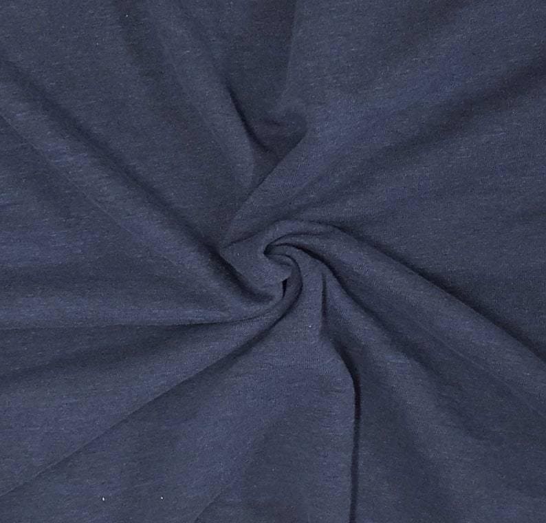 May include: A dark navy blue fabric with a heathered texture, featuring a soft, matte finish and a series of deep, radiating folds that create a dynamic, swirling pattern across the surface of the material, highlighting its flexible quality.