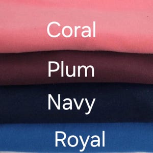 May include: A stack of fabric samples in coral, plum, navy, and royal blue. The names of the colors are displayed in white text over each respective fabric swatch. The fabrics appear to be soft and folded.