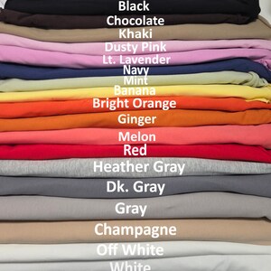 May include: A stack of folded fabric in various colors labeled with text: Black, Chocolate, Khaki, Dusty Pink, Lt. Lavender, Navy, Mint, Banana, Bright Orange, Ginger, Melon, Red, Heather Gray, Dk. Gray, Gray, Champagne, Off White, and White.