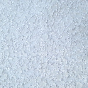 May include: A close-up of a light blue textured surface with a subtle pattern.
