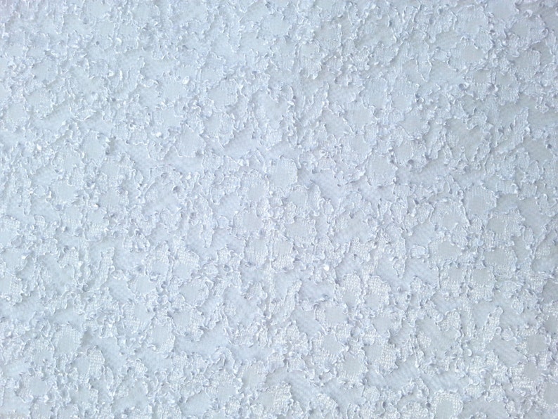 May include: A close-up of a light blue textured surface with a subtle pattern.
