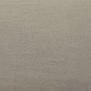 May include: A plain, light gray fabric with a subtle texture.