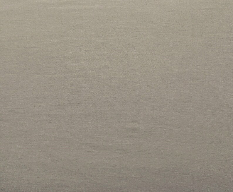 May include: A plain, light gray fabric with a subtle texture.
