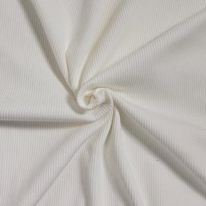May include: White ribbed fabric with a soft, textured surface. The fabric is folded and draped, showcasing its texture and drape.