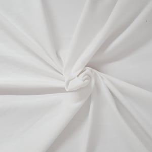 May include: A solid white fabric featuring a smooth, matte texture. The material is gathered at the center, creating soft, radiating folds and deep shadows that extend outward toward the edges, highlighting the clean, bright white color.